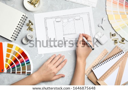 Interior designer planning bedroom at marble table, top view