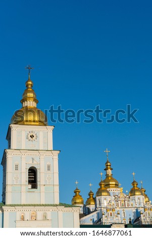 Orthodox temple with golden baths on a blue background. The concept of Orthodoxy. vertical photo