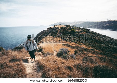 Woman photographer hiking on Makara, Wellington, NZ