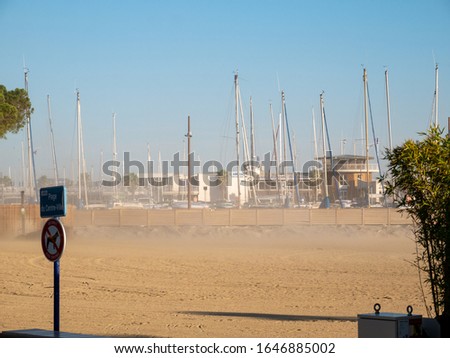 Beach with view to the harbour with many sailing boats in south france french riviera