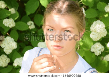 Fashion model posing over green natural background. Stock Photo