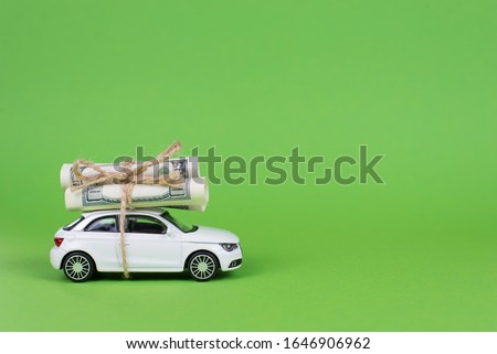 Earn cash with your car concept. Side profile full photo picture of small white car with rolls piles of usd money on top isolated bright color background with copyspace card