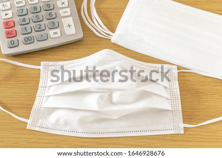 White mask and calculator placed on the table