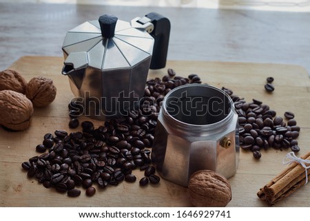 Coffee maker with coffee beans and cinnamon bars.
