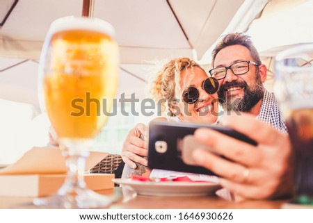 Happy people adult couple do video call together with modern phone device - technology concept to stay connected everywhere with internet wifi - love and relationship forever