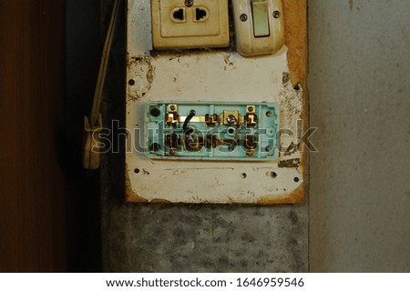 Old and dirty light switch on grunge wall background