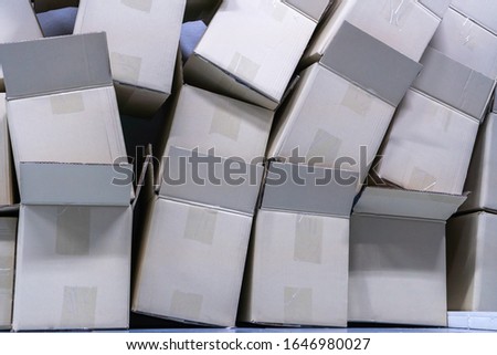 Pile of Brown delivery cardboard packaging boxes of various sizes for production distribution arranged shipping, Opened cartoon boxs service courier with parcels, Online logistic transport concept