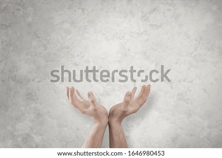 Hands arranged in a gesture of support. Two hands stacked next to each other cover the world. Help and support concept for the world. The whole world in your hands.