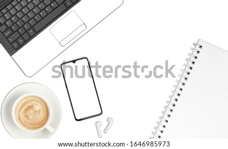 Top view office table desk, mobile phone, laptop, notebook, pencil, wireless headphones, and coffee cups on a white background.