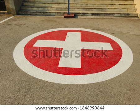 Red emergency stop sign and broken car on the road