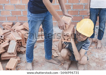 Children working at construction site for world day against child labor concept: Royalty-Free Stock Photo #1646996731