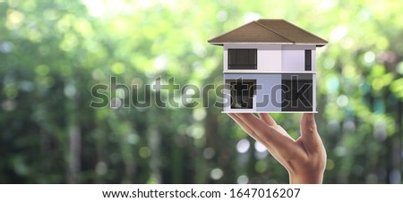 House Residential Structure in a hand ,business home idea