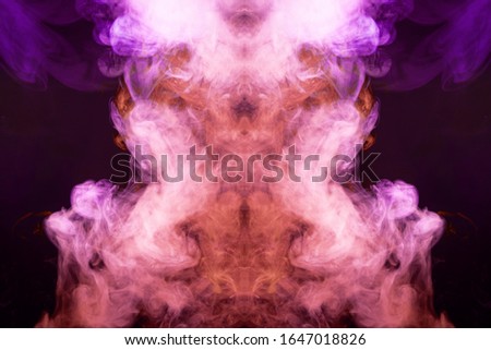 
Red  and pink cloud of smoke of  black isolated background in the form of a skull, monster, dragon on a black isolated background. Mocap for cool t-shirts
