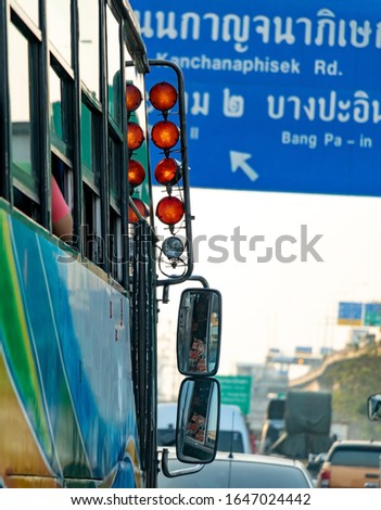 Stop lights installed on a rod above the rearview mirrors for bus driver on the road at Bangkok.