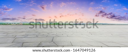 Wide square floor and city suburb skyline at sunset in Shanghai,panoramic view.