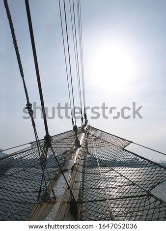 Journey begins on sunny day, Sailing Ship bow with bowsprit pointing to the sun