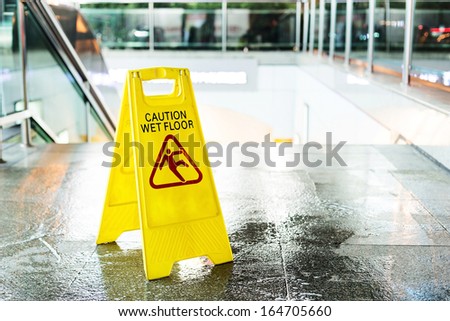 Sign showing warning of caution wet floor  Royalty-Free Stock Photo #164705660