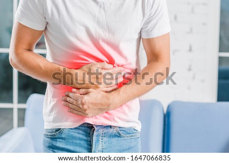 Man holding stomach due to stomach pain and burning Royalty-Free Stock Photo #1647066835