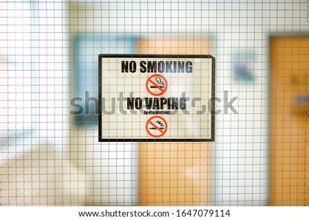 No smoking sign and No vaping sign with blurred indoor office building school campus background. 