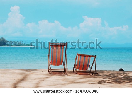 Lounge chairs on a beautiful tropical beach  Royalty-Free Stock Photo #1647096040