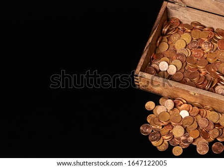 Euro coins in chest on black backgrtound. View from top. Royalty-Free Stock Photo #1647122005