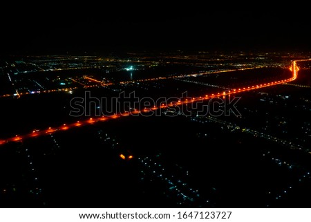 A view looking down on the city from the air at night plane thailand