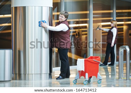 two woman cleaner worker in uniform cleaning indoor interior of business building Royalty-Free Stock Photo #164713412