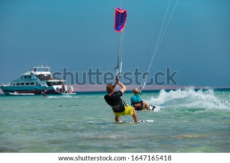 Kitesurfing on the waves of the Red sea, Egipt. Kitesurfing, Kiteboarding action photos Kitesurfers In action