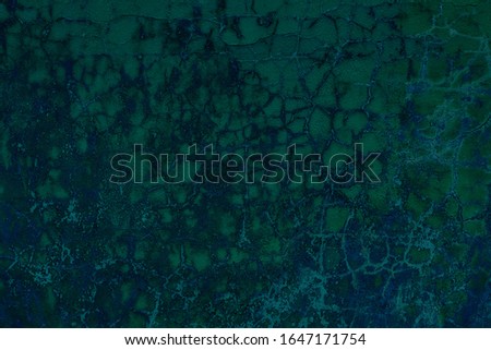 fantastic turquoise painted wall with cracks and peeling paint flakes