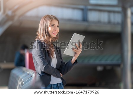 Portrait of business woman happy smile looking digital tablet on blurred background. Business success concept.