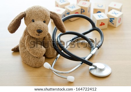 Pediatrics. Puppy toy with medical equipment Royalty-Free Stock Photo #164722412