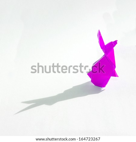 Pink Origami rabbit isolated on white