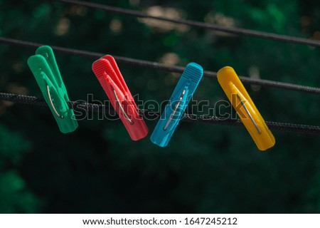 clothespins, colorful clothespins for clothes on a rope in the fresh air in the summer