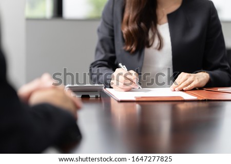 A Japanese tax accountant hearing about your insurance and inheritance concerns Royalty-Free Stock Photo #1647277825