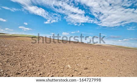plowed field in autumn with blue sky