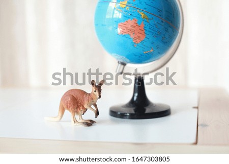 Globe stands on a desk in a classroom