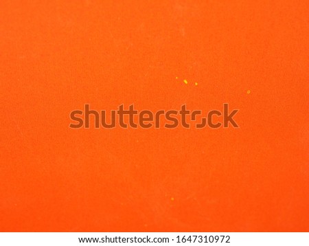Orange colored paper background texture. Grunge image.  