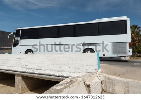 View to bridge above dry canal with big bus.