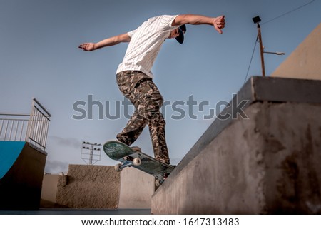 young skater does a trick called frontside croocked in a skate park