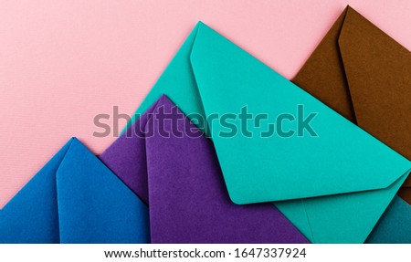 Mail envelopes on color background. Different colored envelopes on the table.