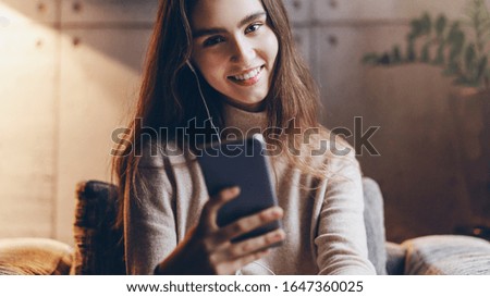 Young girl doing selfie on camera of mobile phone. Person using smartphone for internet communication. Woman shooting stories and pictures for social networks and online followers. Installing web apps
