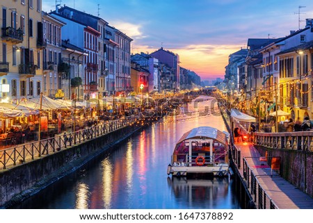 Naviglio Grande canal in Milan city, Italy, a popular tourist area, on dramatic sunset Royalty-Free Stock Photo #1647378892