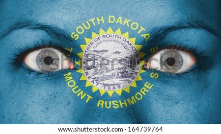 Close up of eyes. Painted face with flag of South Dakota