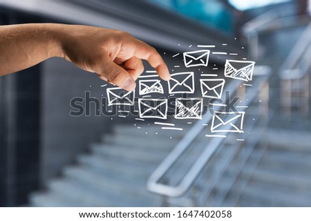 The human hand holds an abstract envelope icon