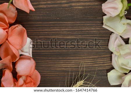 Dried barley and rose leaves on a wooden table