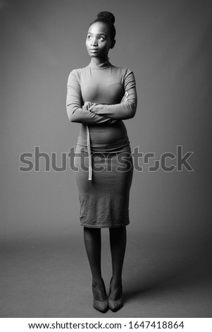 Young beautiful African Zulu businesswoman against gray background