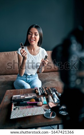 Young asian makeup artist doing video blog about cosmetics. Makeup tutorial. Beauty concept