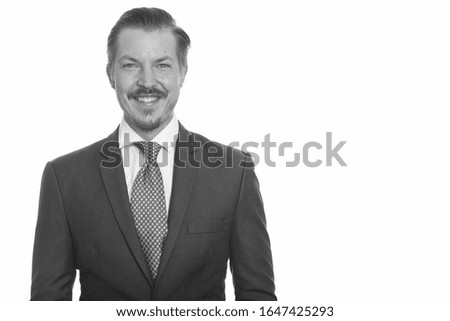 Portrait of happy young handsome man with mustache smiling