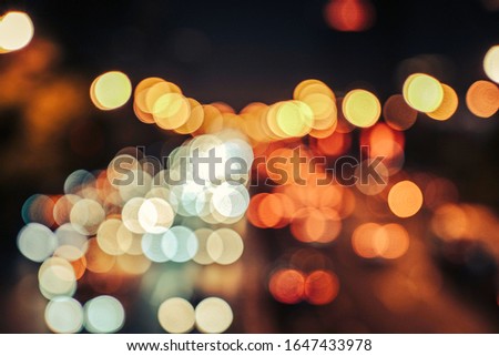 Blur focused urban abstract texture bokeh city lights & traffic jams. Looking out from the windshield of the car cab.
