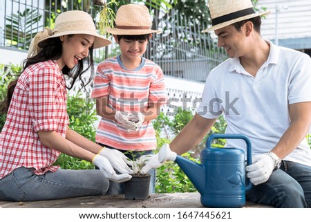 Happy family, Gardening in the house, Cute boy helps his parents to take care of trees.